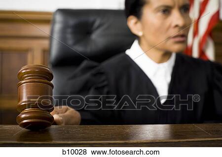 Female judge holding a gavel View Large Photo Image Stock Photo - Female judge holding a gavel. Fotosearch