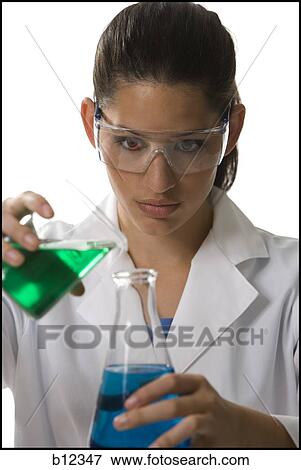 Stock Photo - Female lab worker testing and experimenting. Fotosearch