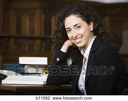 Female lawyer smiling in courtroom View Large Photo Image Stock Image - Female lawyer smiling in courtroom. Fotosearch