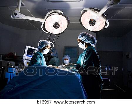 Female nurse and surgeon in scrubs during surgery View Large Photo Image Stock Photo - Female nurse and surgeon in scrubs during surgery. Fotosearch