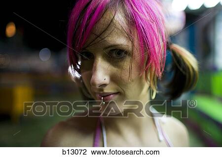 Stock Image - Female punk with dyed pink hair. Fotosearch