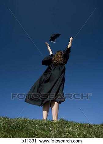 Stock Image - Female student celebrating graduation. Fotosearch