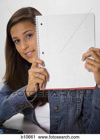 Female student holding blank workbook View Large Photo Image Stock Image - Female student holding blank workbook. Fotosearch