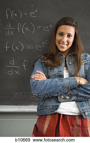 Stock Photo - Female student leaning against chalkboard. Fotosearch