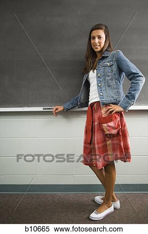 Female student leaning against chalkboard View Large Photo Image Stock Photography - Female student leaning against chalkboard. Fotosearch