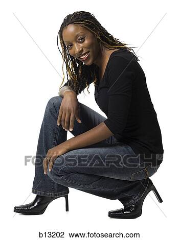 Female with braided hair crouching View Large Photo Image Stock Image - Female with braided hair crouching. Fotosearch