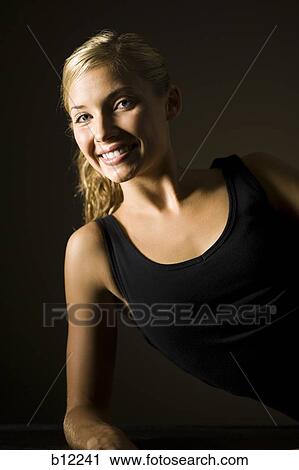 Stock Image - Fit exercising woman taking a break. Fotosearch