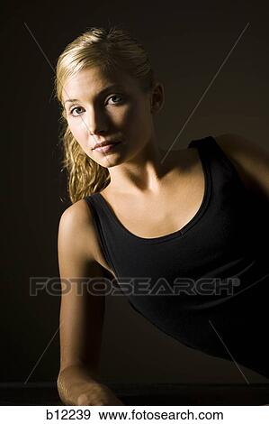 Fit exercising woman taking a break View Large Photo Image Stock Photo - Fit exercising woman taking a break. Fotosearch