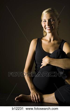 Stock Image - Fit woman stretching and exercising. Fotosearch
