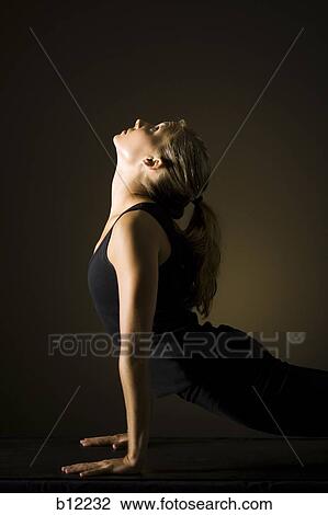 Fit woman stretching and exercising View Large Photo Image Stock Image - Fit woman stretching and exercising. Fotosearch