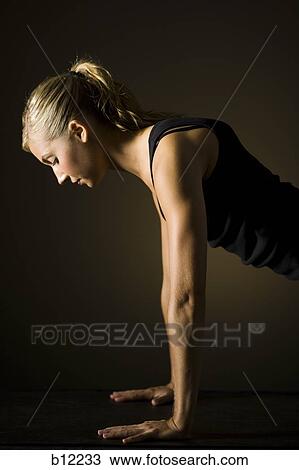 Fit woman stretching and exercising View Large Photo Image Stock Image - Fit woman stretching and exercising. Fotosearch