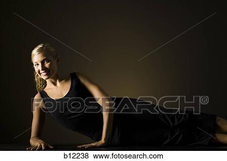 Stock Photo - Fit woman stretching and exercising. Fotosearch