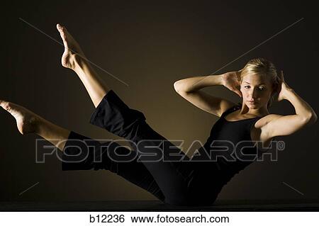 Stock Photograph - Fit woman stretching and exercising. Fotosearch