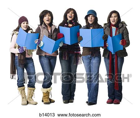Stock Image - Five women in winter coats singing with sheet music. Fotosearch