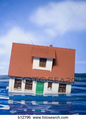 Flooded toy house floating in water View Large Photo Image Stock Photograph - Flooded toy house floating in water. Fotosearch