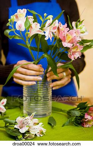 Picture - Florist preparing floral arrangement. Fotosearch