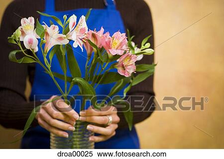 Stock Photography - Florist preparing floral arrangement. Fotosearch