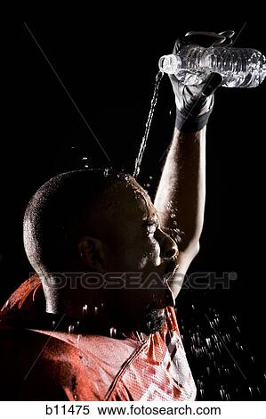 Stock Photography - Football player cooling off with water. Fotosearch