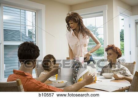 Four mannequins portraying a family at the dining table View Large Photo Image Stock Photo - Four mannequins portraying a family at the dining table. Fotosearch