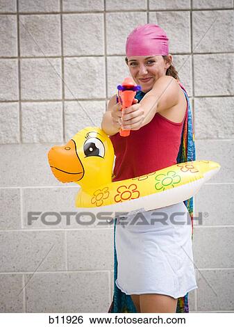 Girl at swimming pool with life ring and water pistol View Large Photo Image Stock Photograph - Girl at swimming pool with life ring and water pistol. Fotosearch