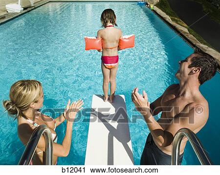Girl diving into swimming pool View Large Photo Image Stock Image - Girl diving into swimming pool. Fotosearch