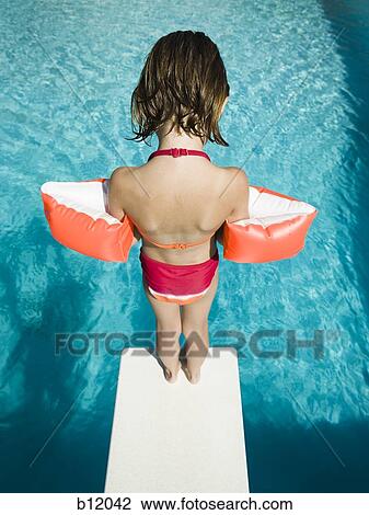 Girl diving into swimming pool View Large Photo Image Stock Image - Girl diving into swimming pool. Fotosearch
