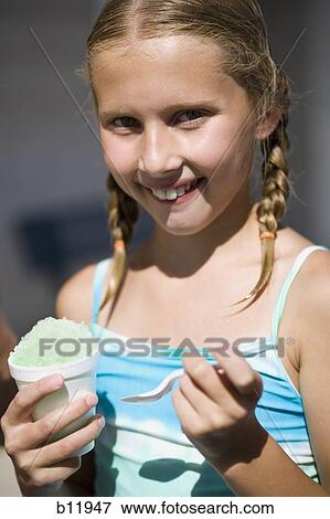 Stock Photo - Girl eating slushy. Fotosearch