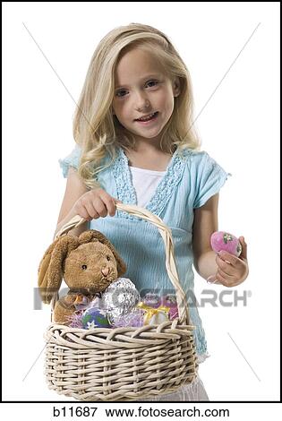 Stock Photo - Girl holding Easter basket. Fotosearch