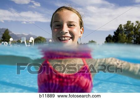 Stock Photo - Girl in a swimming pool. Fotosearch