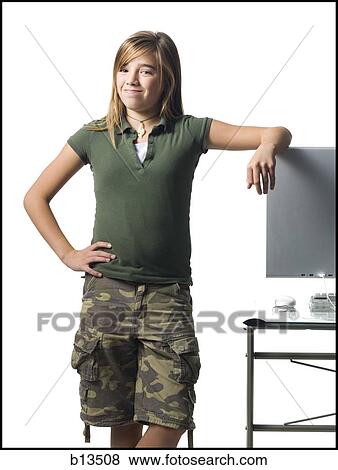 Girl leaning on computer monitor smiling View Large Photo Image Stock Photo - Girl leaning on computer monitor smiling. Fotosearch