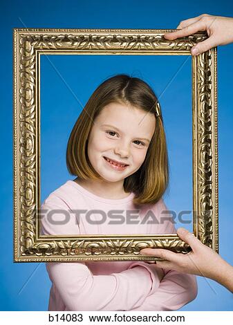 Girl looking through picture frame smiling View Large Photo Image Stock Image - Girl looking through picture frame smiling. Fotosearch
