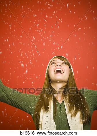 Girl looking up at snow View Large Photo Image Stock Photograph - Girl looking up at snow. Fotosearch