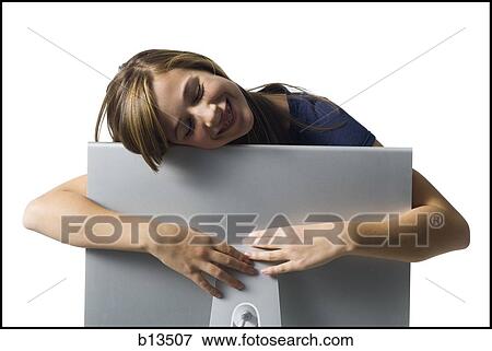 Girl resting on computer monitor smiling View Large Photo Image Stock Photo - Girl resting on computer monitor smiling. Fotosearch