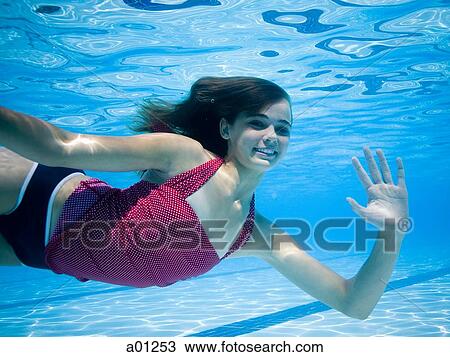 Girl swimming underwater in pool View Large Photo Image Stock Image - Girl swimming underwater in pool. Fotosearch