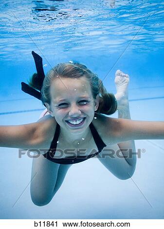 Girl swimming underwater in pool View Large Photo Image Stock Image - Girl swimming underwater in pool. Fotosearch