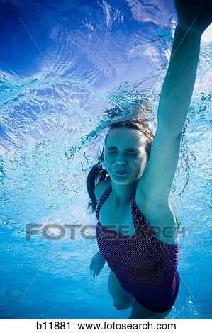 Girl swimming underwater in pool View Large Photo Image Stock Image - Girl swimming underwater in pool. Fotosearch