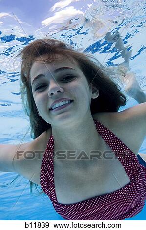 Girl swimming underwater in pool View Large Photo Image Stock Photo - Girl swimming underwater in pool. Fotosearch