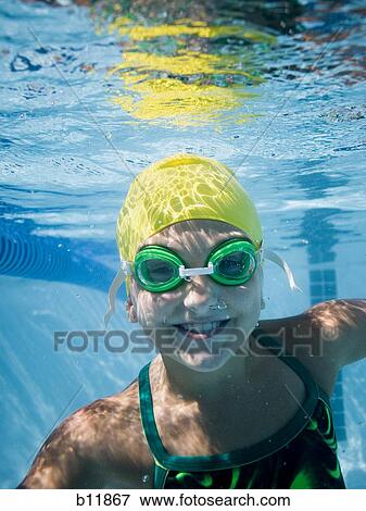 Girl swimming underwater in pool View Large Photo Image Stock Photo - Girl swimming underwater in pool. Fotosearch