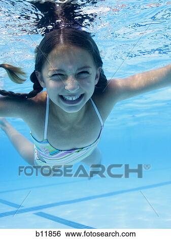 Stock Photograph - Girl swimming underwater in pool. Fotosearch