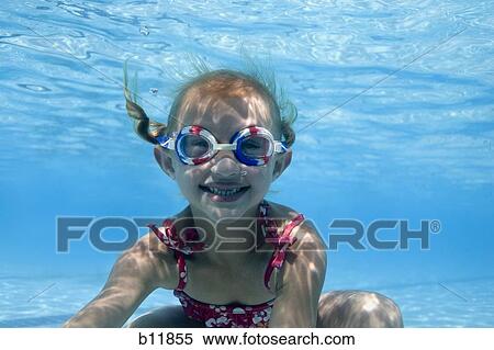 Stock Photography - Girl swimming underwater in pool. Fotosearch