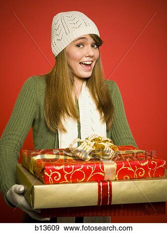 Girl with Christmas gifts and toque View Large Photo Image Stock Photo - Girl with Christmas gifts and toque. Fotosearch