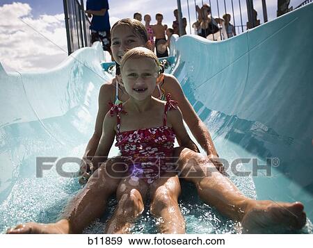Stock Photo - Girls on a waterslide. Fotosearch