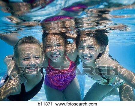 Girls swimming underwater in pool View Large Photo Image Stock Image - Girls swimming underwater in pool. Fotosearch