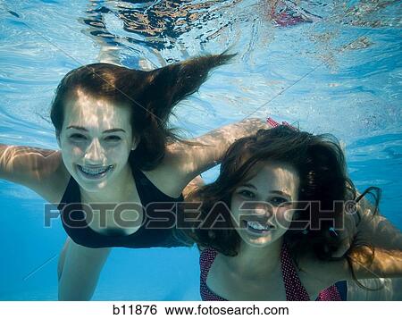 Girls swimming underwater in pool View Large Photo Image Stock Photograph - Girls swimming underwater in pool. Fotosearch