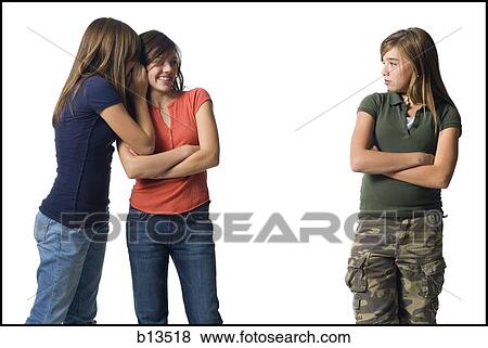 Girls whispering about another girl View Large Photo Image Stock Photo - Girls whispering about another girl. Fotosearch