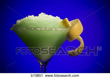 Green slush beverage in cocktail glass with lemon garnish View Large Photo Image Stock Image - Green slush beverage in cocktail glass with lemon garnish. Fotosearch
