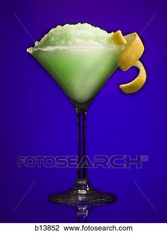 Green slush beverage in cocktail glass with lemon garnish View Large Photo Image Stock Image - Green slush beverage in cocktail glass with lemon garnish. Fotosearch