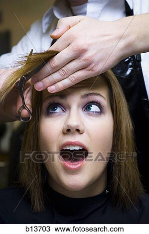 Hairdresser cutting young woman's hair View Large Photo Image Stock Image - Hairdresser cutting young woman's hair. Fotosearch