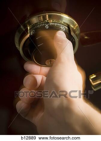 Hand opening combination lock View Large Photo Image Stock Photo - Hand opening combination lock. Fotosearch