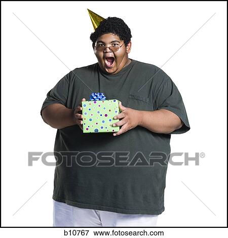Heavyset young man celebrating birthday View Large Photo Image Stock Photo - Heavyset young man celebrating birthday. Fotosearch